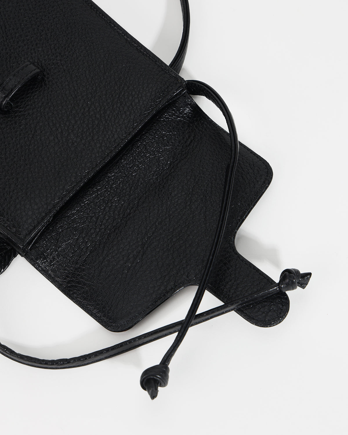 Black leather bag with drawstring on a white background