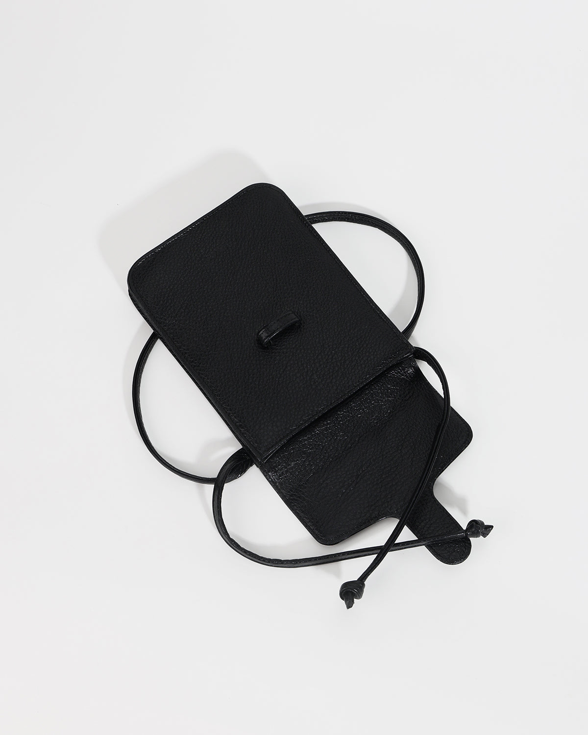 Black leather crossbody bag on a light gray background