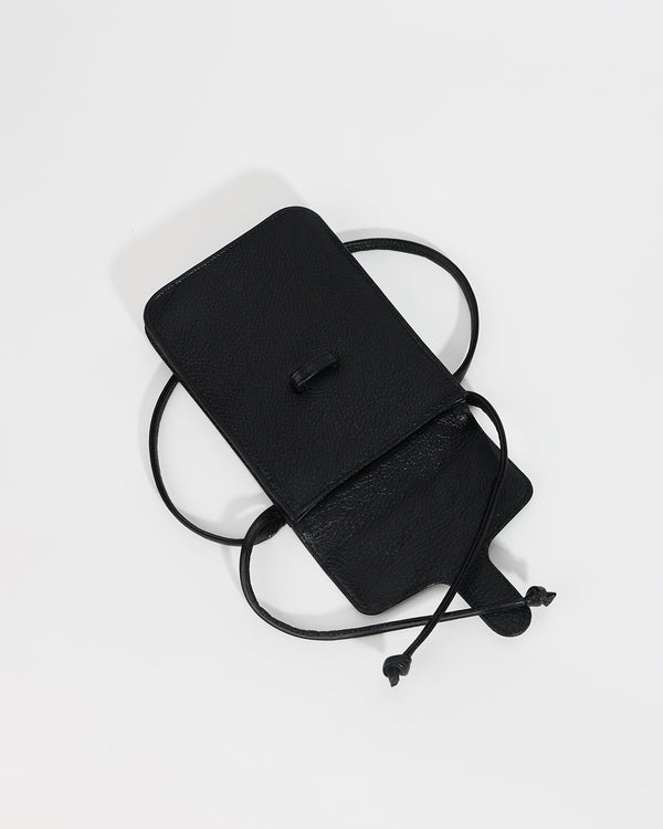 Black leather crossbody bag on a light gray background