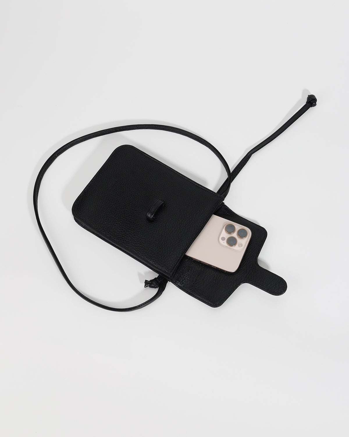 Black phone bag with a strap on a light gray background