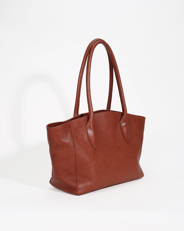 Brown leather tote bag on a white background