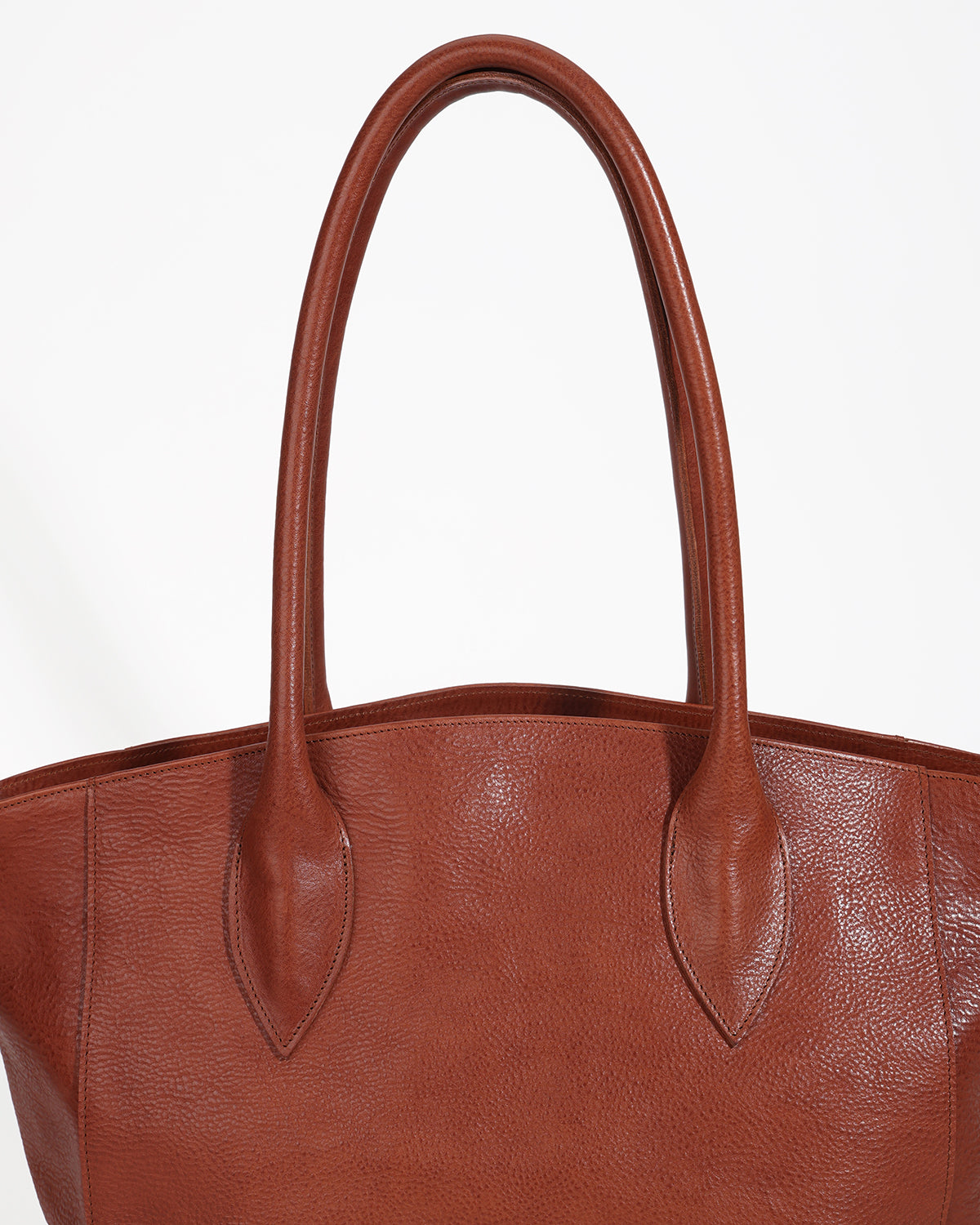 Brown leather tote bag with handles on a white background