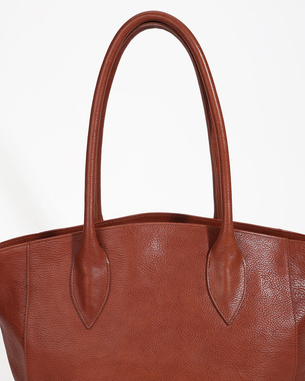 Brown leather tote bag with handles on a white background