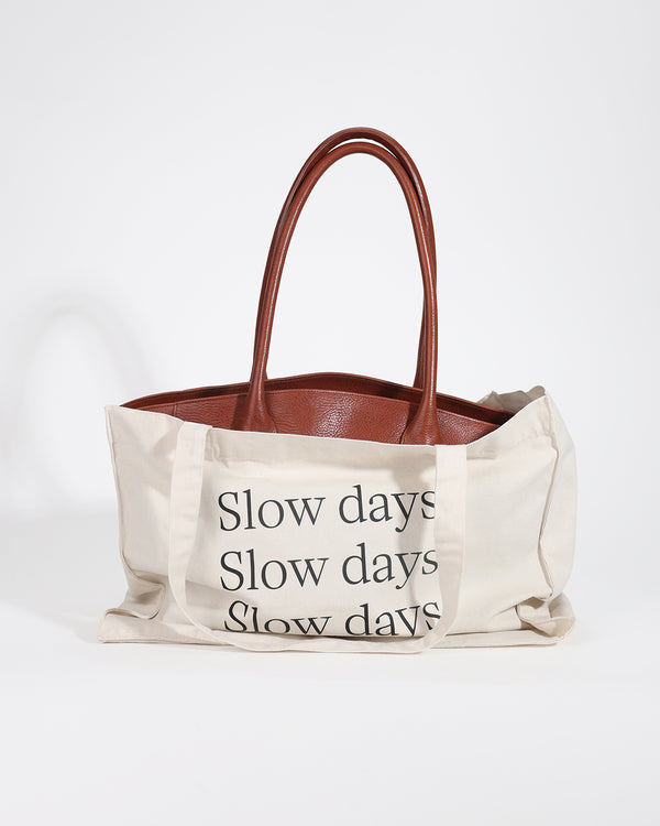 Tote bag with 'Slow days' text on a white background