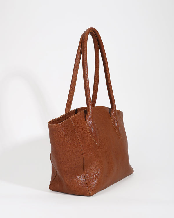 Brown leather tote bag on a white background