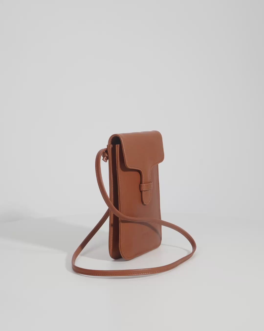 Video of a brown leather phone bag